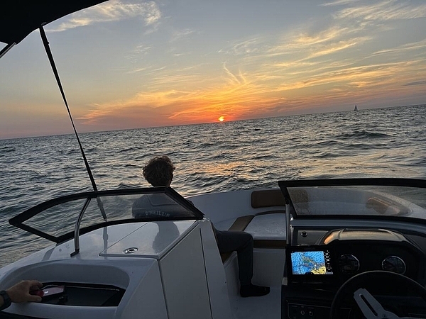 Captain Ridge drives during golden hour on a St. Pete Sun Cruise sunset tour.