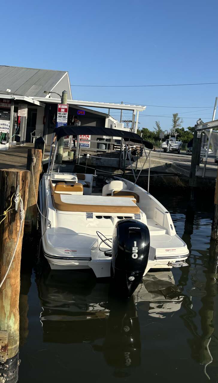 Docked in front of a St. Petersburg home, a St. Pete Sun Cruise boat awaits boarding.